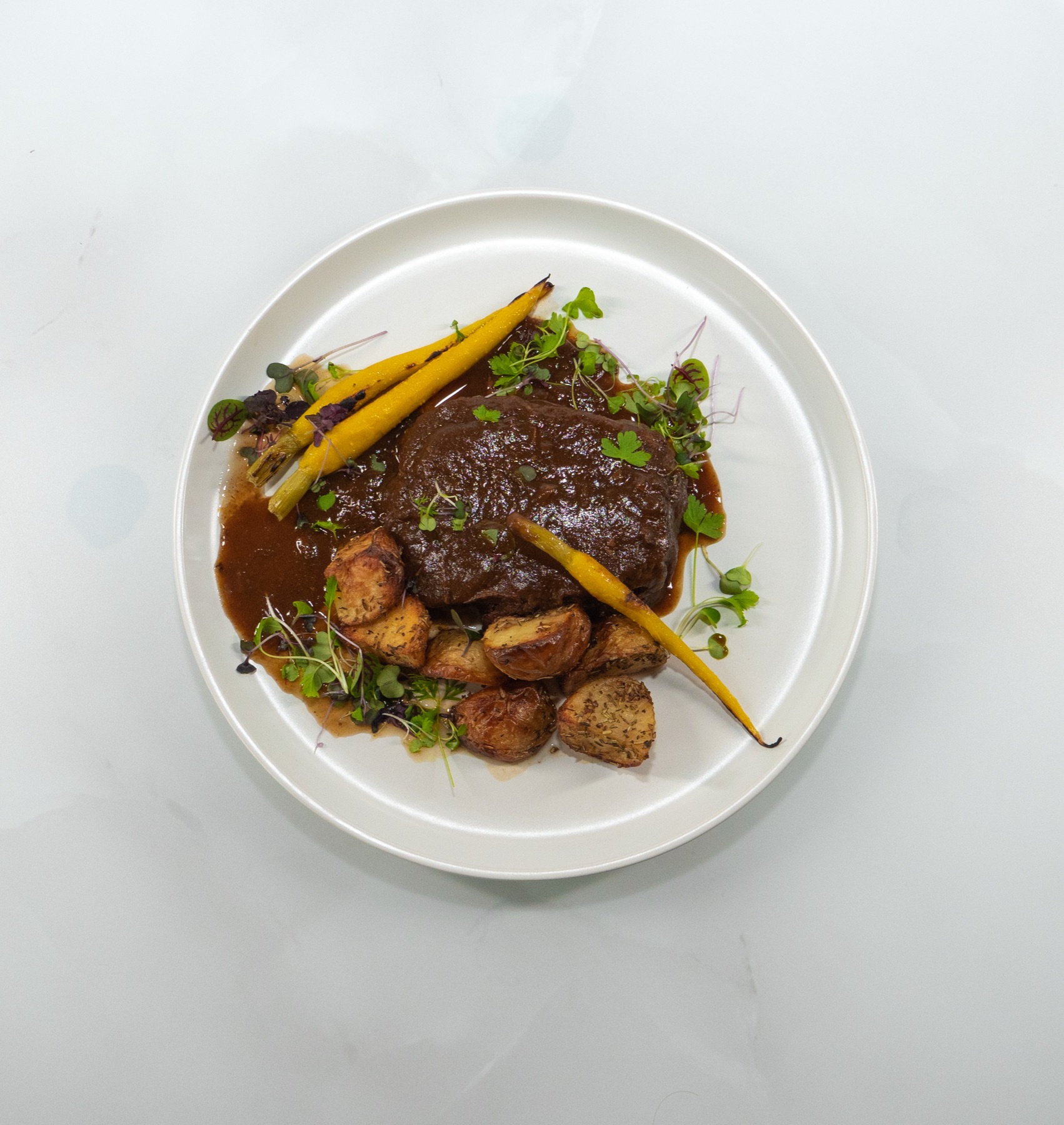 Braised beef main course plated for a Sydney engagement party by Chef Michele