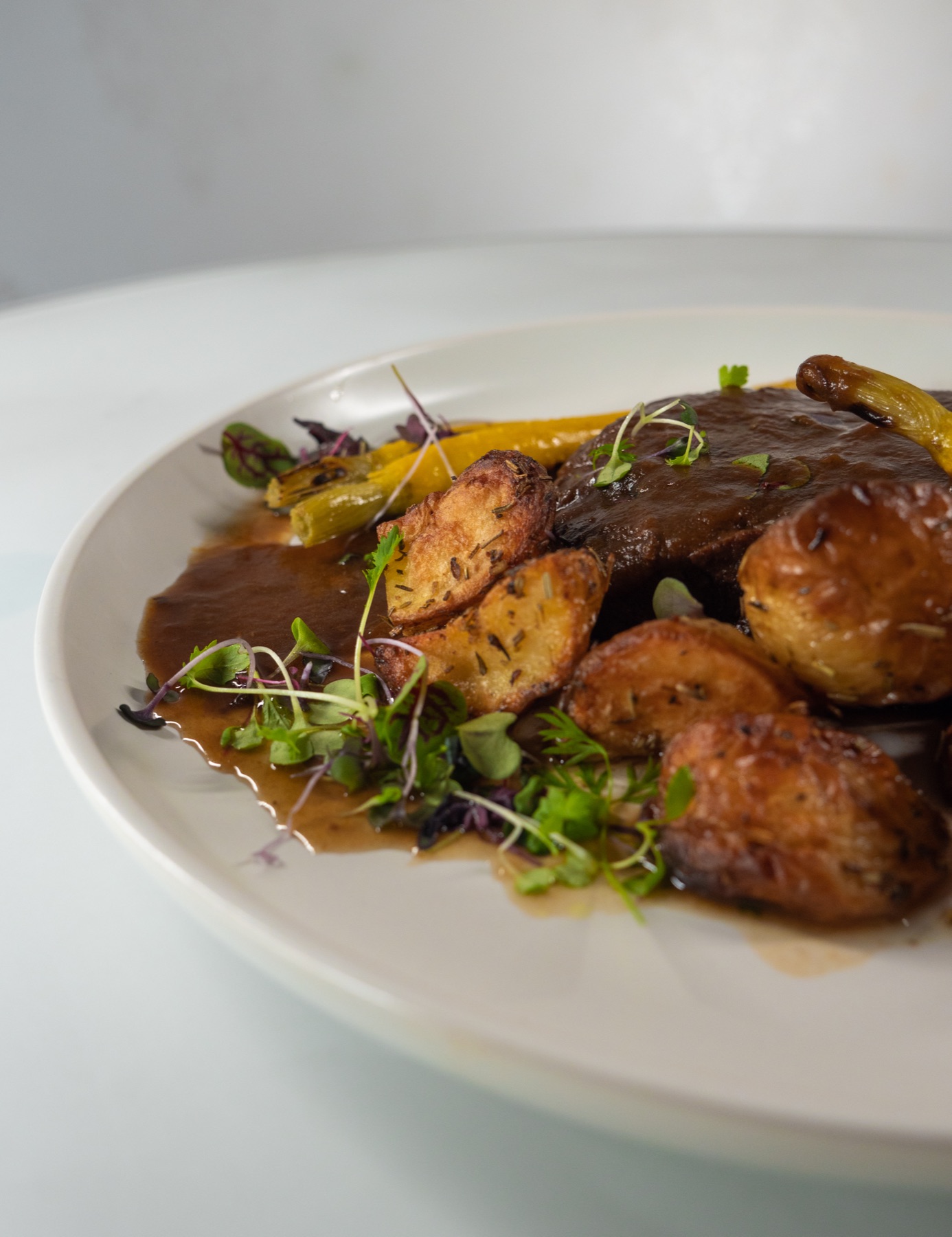 Close-up of braised beef with roasted potatoes, Italian catering for a Sydney engagement party