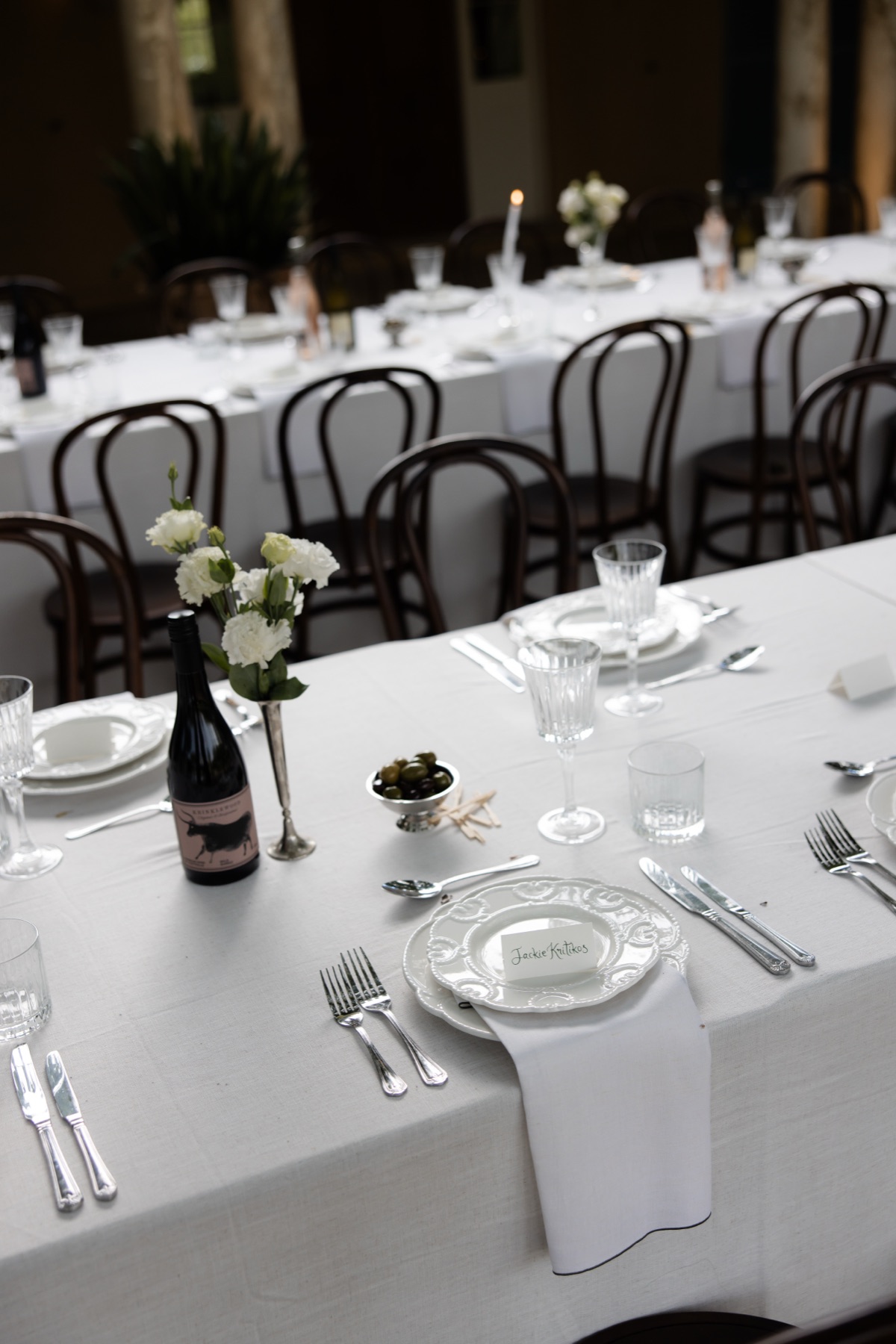 Elegant wedding reception table setting with white linen, silverware and place cards, Michelone at Home Sydney